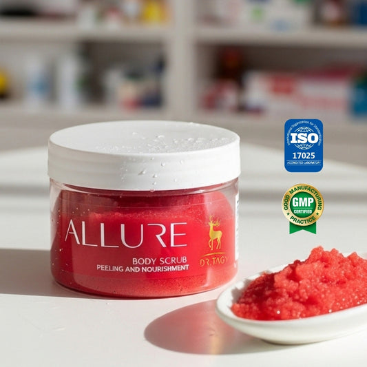 Red jar of Dr. Tagy Allure Body Scrub displayed on a white surface with a small dish of red exfoliating crystals beside it, featuring GMP and ISO certification logos — highlighting luxurious body care and natural exfoliation.