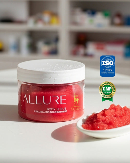Red jar of Dr. Tagy Allure Body Scrub displayed on a white surface with a small dish of red exfoliating crystals beside it, featuring GMP and ISO certification logos — highlighting luxurious body care and natural exfoliation.