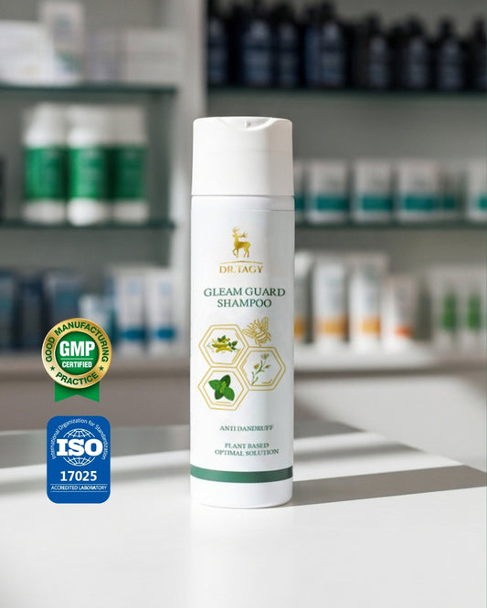 Dr. Tagy Gleam Guard Shampoo bottle with anti-hair loss and strengthening formula, placed on a white surface with GMP and ISO certification logos in the background.