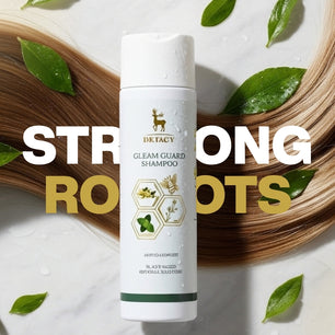 Promotional image of Dr. Tagy Gleam Guard Shampoo bottle placed on a marble surface with green leaves and long, shiny hair strands in the background, featuring the text “Strong Roots.”