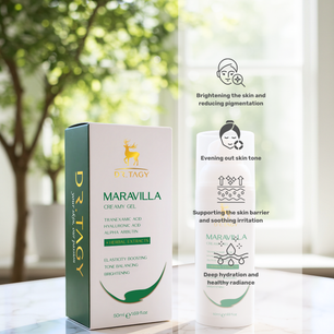Dr. Tagy Maravilla Creamy Gel bottle and packaging on a marble surface with icons describing benefits like brightening the skin, evening skin tone, soothing irritation, and deep hydration, against a natural green background.