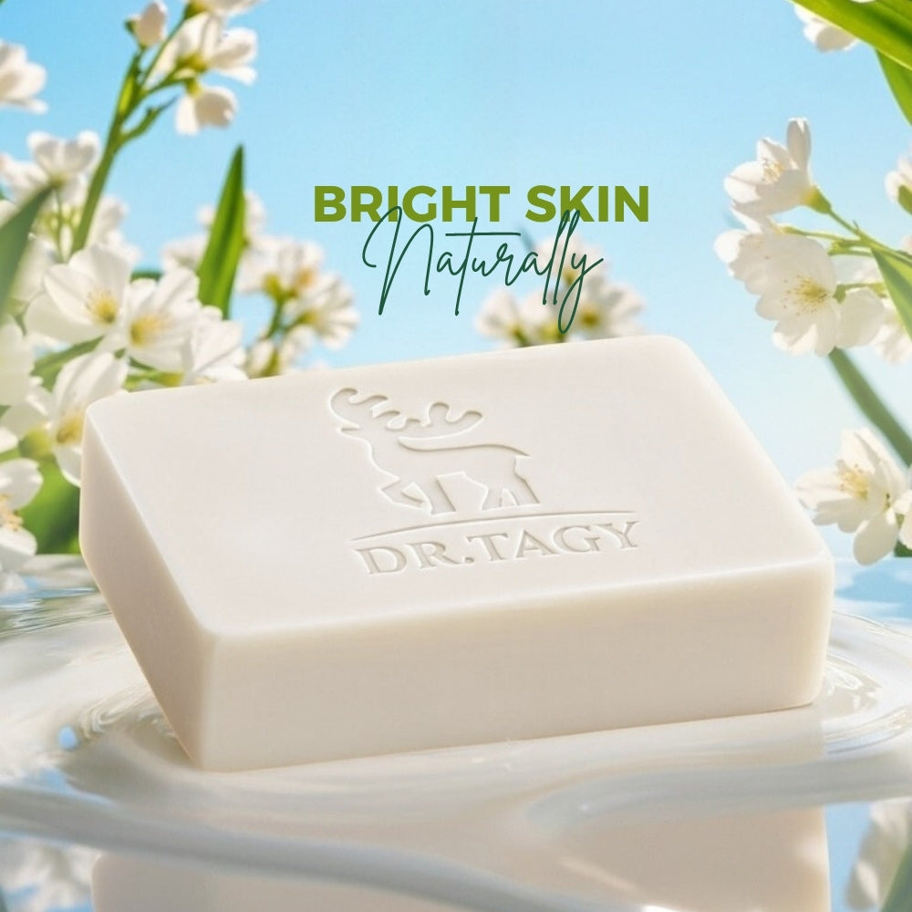 Dr. Tagy Deer Milk Soap bar with white flowers and blue sky background, featuring the phrase Bright Skin Naturally.